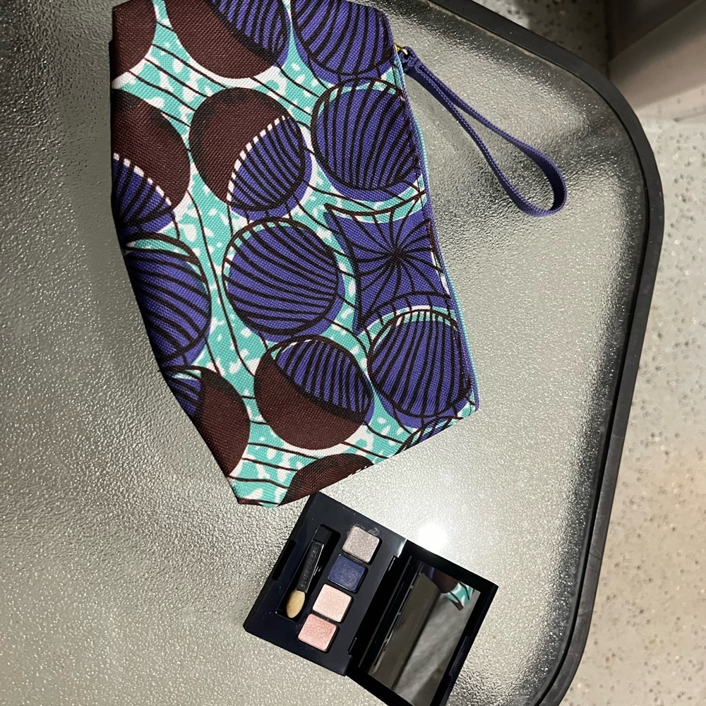 Estee Lauder blue and purple makeup bag with zipper pocket and magnetic makeup